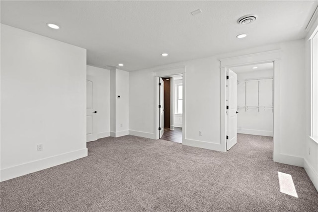 1003 Commercial St, Atchison, KS 66002 - spare room featuring carpet flooring, recessed lighting, and baseboards