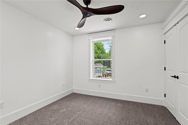 1003 Commercial St, Atchison, KS 66002 - unfurnished room with dark colored carpet, baseboards, a ceiling fan, and recessed lighting