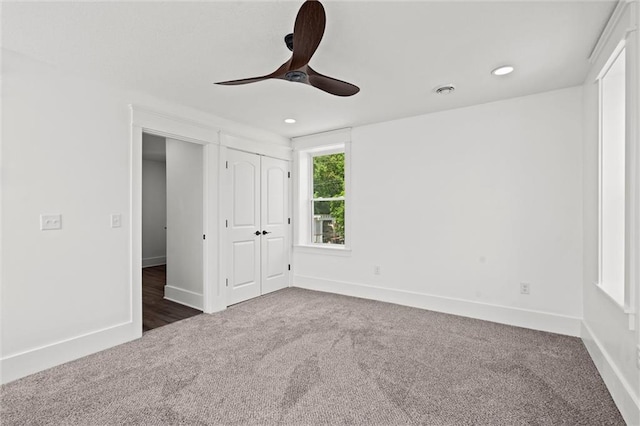 1003 Commercial St, Atchison, KS 66002 - unfurnished bedroom featuring carpet, baseboards, recessed lighting, a ceiling fan, and a closet