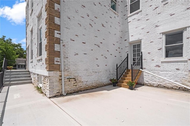 1003 Commercial St, Atchison, KS 66002 - property entrance with a patio and brick siding