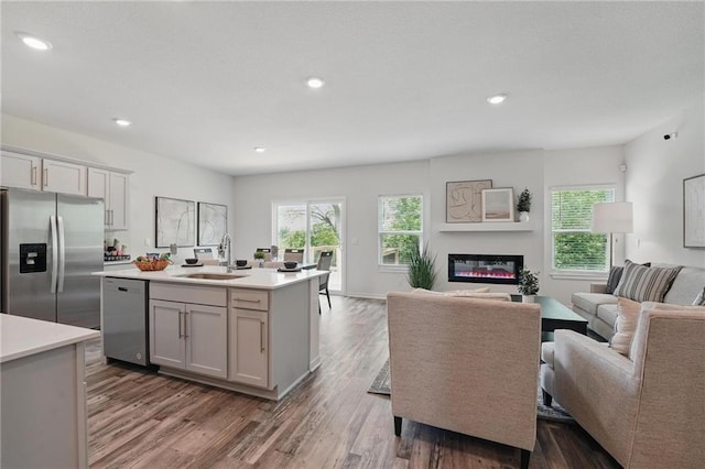 7708 NE 107th Ter, Kansas City, MO 64157 - kitchen with appliances with stainless steel finishes, a sink, open floor plan, light countertops, and recessed lighting