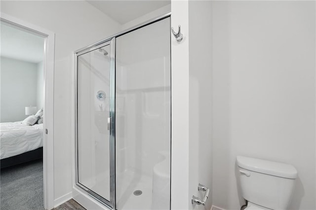 7708 NE 107th Ter, Kansas City, MO 64157 - ensuite bathroom featuring a shower stall, toilet, and baseboards