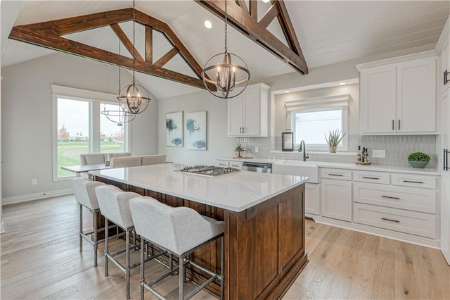 17162 S Hall St, Olathe, KS 66062 - kitchen with a chandelier, a center island, stainless steel appliances, light wood-style floors, and recessed lighting