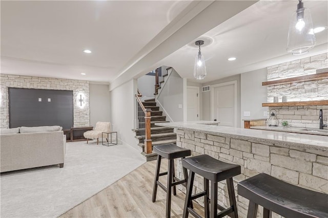 17162 S Hall St, Olathe, KS 66062 - indoor wet bar with stairs, light wood finished floors, recessed lighting, and decorative light fixtures