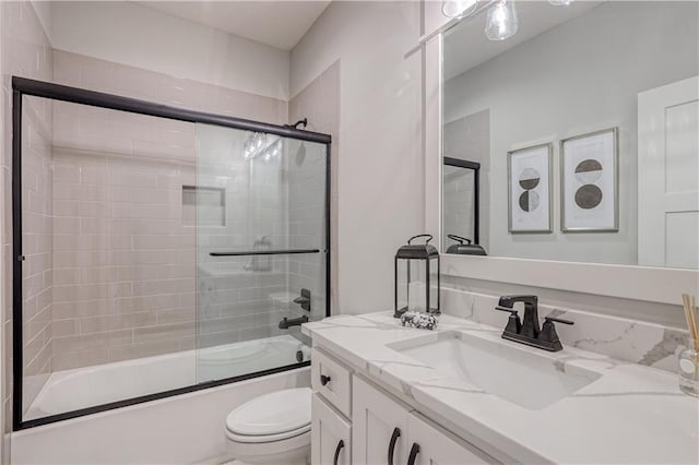 17162 S Hall St, Olathe, KS 66062 - bathroom featuring vanity, toilet, and shower / bath combination with glass door