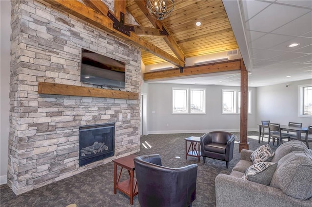 17162 S Hall St, Olathe, KS 66062 - carpeted living room with a stone fireplace, baseboards, recessed lighting, and wooden ceiling with exposed beams