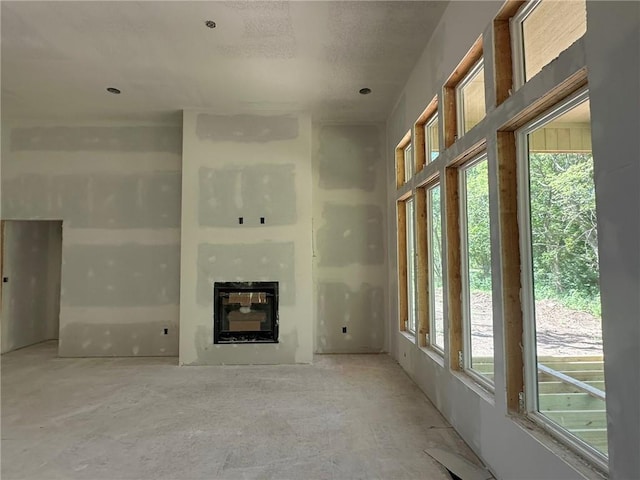 17162 S Hall St, Olathe, KS 66062 - unfurnished living room featuring plenty of natural light and a glass covered fireplace