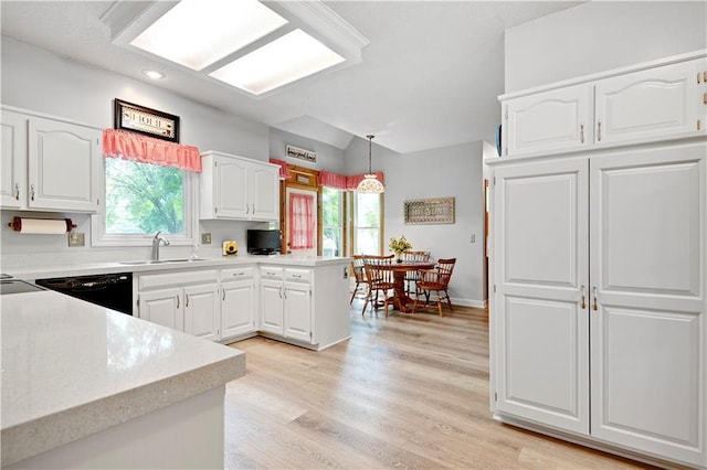 8215 W 150th St, Overland Park, KS 66223 - kitchen featuring dishwasher, light countertops, healthy amount of natural light, white cabinets, and recessed lighting