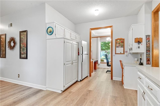8215 W 150th St, Overland Park, KS 66223 - corridor with light wood-type flooring, baseboards, and a textured ceiling