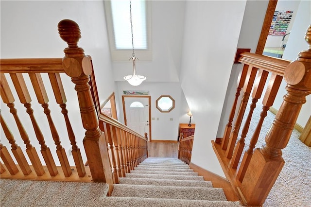 8215 W 150th St, Overland Park, KS 66223 - staircase with a towering ceiling, baseboards, and carpet