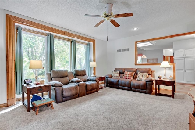 8215 W 150th St, Overland Park, KS 66223 - living area featuring a ceiling fan, a textured ceiling, and carpet