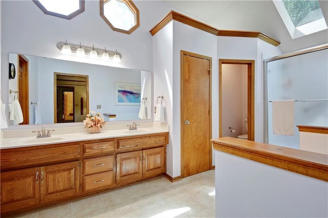 8215 W 150th St, Overland Park, KS 66223 - full bath featuring a skylight, double vanity, a shower stall, tile patterned floors, and toilet