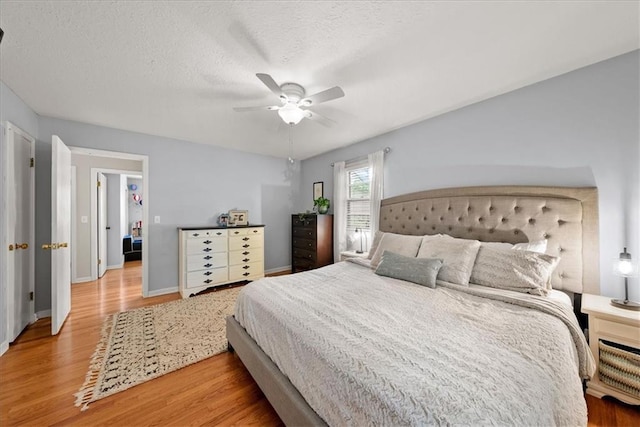 607 E 110th St, Kansas City, MO 64131 - bedroom featuring wood finished floors, a ceiling fan, baseboards, and a textured ceiling