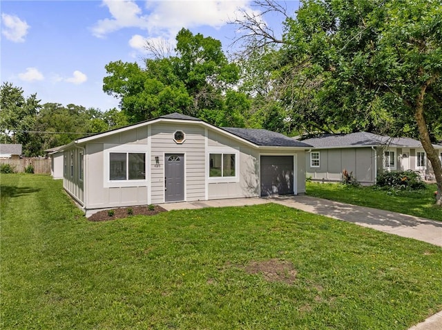 423 N Walnut St, Olathe, KS 66061 - single story home featuring an attached garage, concrete driveway, a front lawn, and board and batten siding
