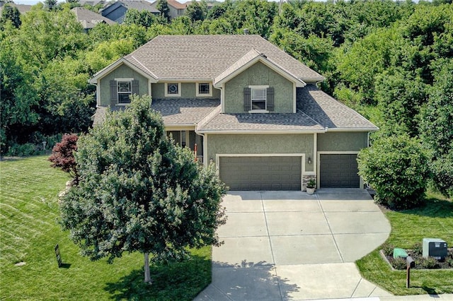 25005 W 85th Ter, Lenexa, KS 66227 - view of front facade with stucco siding, a front lawn, concrete driveway, and a garage