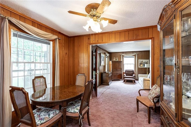 6038 Catalina St, Fairway, KS 66205 - dining room with wooden walls, crown molding, light colored carpet, ceiling fan, and a textured ceiling