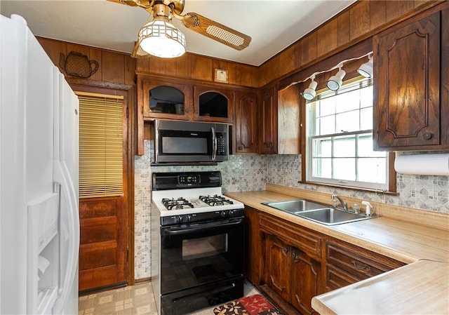 6038 Catalina St, Fairway, KS 66205 - kitchen featuring white refrigerator with ice dispenser, gas range, stainless steel microwave, a sink, and light countertops
