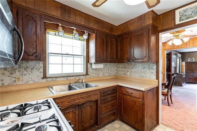 6038 Catalina St, Fairway, KS 66205 - kitchen with a ceiling fan, black microwave, a sink, range with gas cooktop, and wood walls