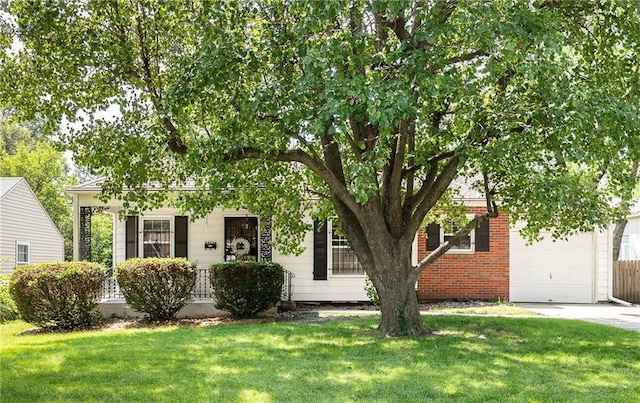 6038 Catalina St, Fairway, KS 66205 - obstructed view of property with a front lawn, driveway, and an attached garage