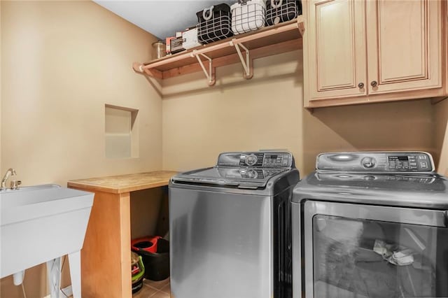 13808 Richards St, Overland Park, KS 66221 - laundry area featuring separate washer and dryer, cabinet space, and tile patterned floors
