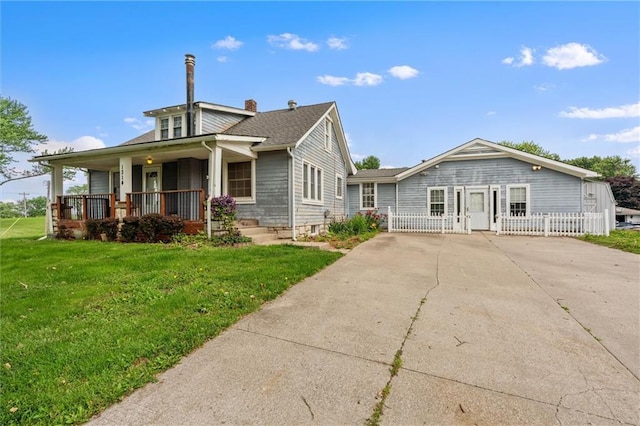 1314 Tracy Ave, Excelsior Springs, MO 64024 - bungalow-style home featuring a porch, driveway, and a chimney