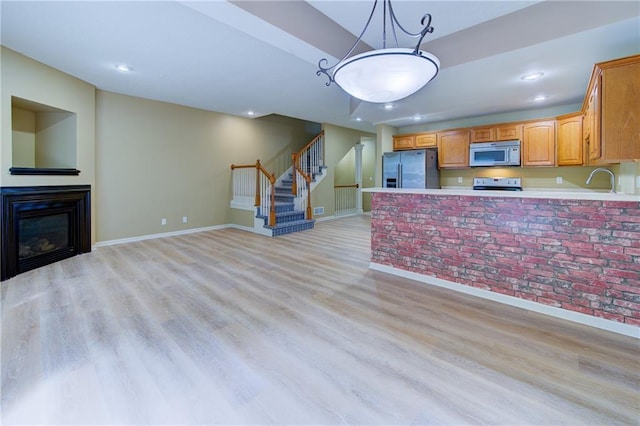 8815 Timber Creek Ln, Pleasant Valley, MO 64068 - kitchen featuring stainless steel refrigerator with ice dispenser, range with electric cooktop, baseboards, light wood-style flooring, and light countertops