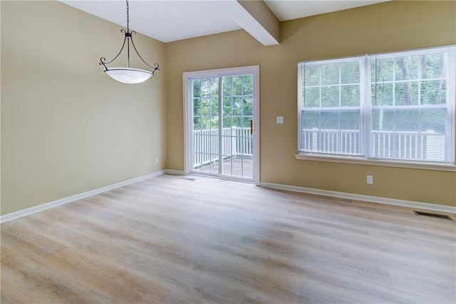 8815 Timber Creek Ln, Pleasant Valley, MO 64068 - unfurnished dining area with light wood-type flooring, baseboards, and beamed ceiling