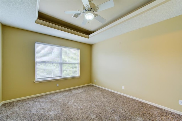 8815 Timber Creek Ln, Pleasant Valley, MO 64068 - carpeted spare room featuring a raised ceiling, baseboards, a ceiling fan, and crown molding