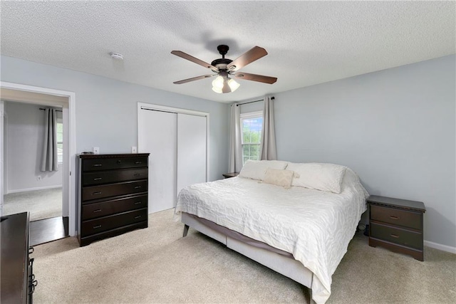 530 Nipper Ln, Leavenworth, KS 66048 - bedroom featuring a closet, carpet flooring, a textured ceiling, ceiling fan, and baseboards