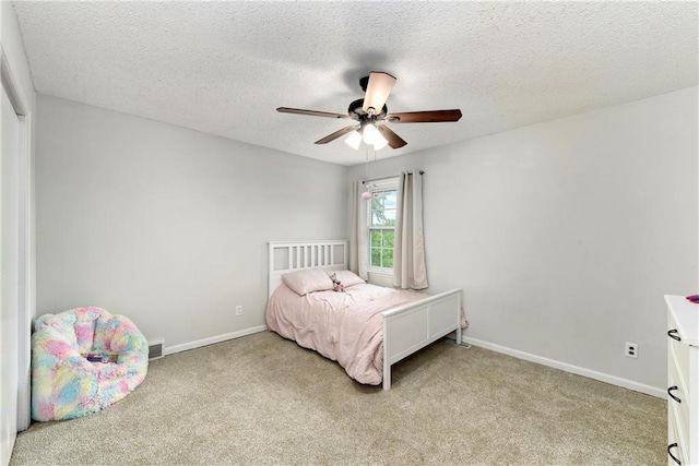 530 Nipper Ln, Leavenworth, KS 66048 - carpeted bedroom featuring baseboards, a textured ceiling, and a ceiling fan