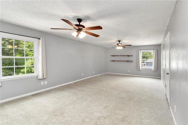 530 Nipper Ln, Leavenworth, KS 66048 - spare room with light colored carpet, a ceiling fan, baseboards, and a textured ceiling