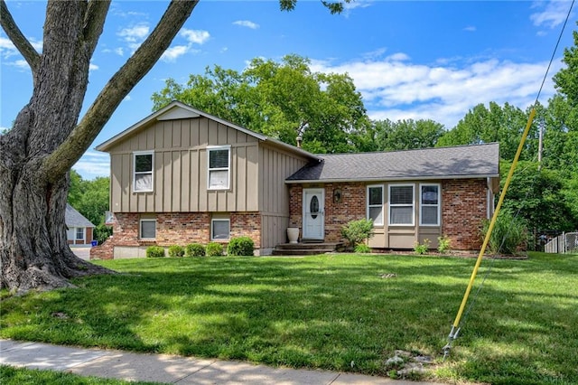 12800 W 100th St, Lenexa, KS 66215 - split level home featuring brick siding, board and batten siding, and a front lawn