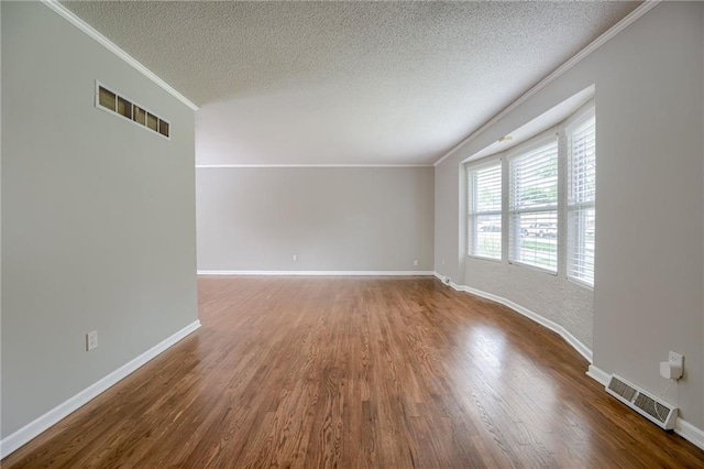 12800 W 100th St, Lenexa, KS 66215 - empty room featuring ornamental molding, a textured ceiling, wood finished floors, and baseboards