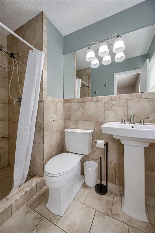 12800 W 100th St, Lenexa, KS 66215 - bathroom featuring tile walls, toilet, a stall shower, a sink, and a textured ceiling