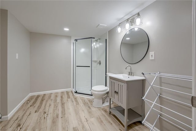 12800 W 100th St, Lenexa, KS 66215 - full bath featuring vanity, wood finished floors, toilet, a stall shower, and baseboards