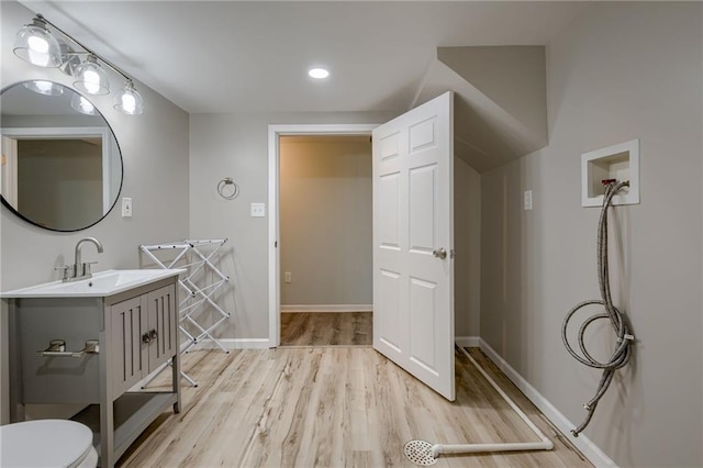 12800 W 100th St, Lenexa, KS 66215 - bathroom featuring wood finished floors, toilet, vanity, baseboards, and recessed lighting