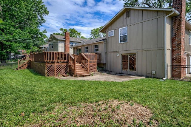12800 W 100th St, Lenexa, KS 66215 - back of property featuring board and batten siding, stairway, a chimney, a deck, and a patio area