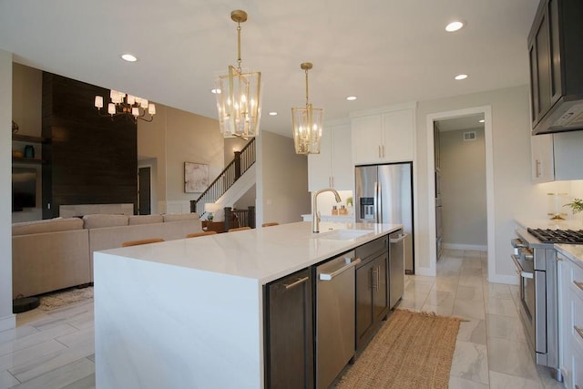 10300 W 174th St, Overland Park, KS 66221 - kitchen with appliances with stainless steel finishes, a chandelier, a sink, light countertops, and recessed lighting