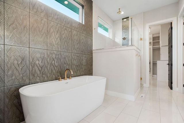 10300 W 174th St, Overland Park, KS 66221 - bathroom featuring a spacious closet, a freestanding tub, tile patterned flooring, walk in shower, and tile walls