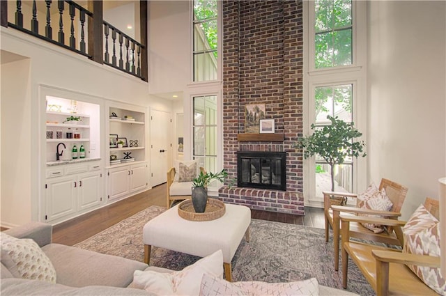 4300 W 112th St, Leawood, KS 66211 - living area with a towering ceiling, wood finished floors, and a fireplace