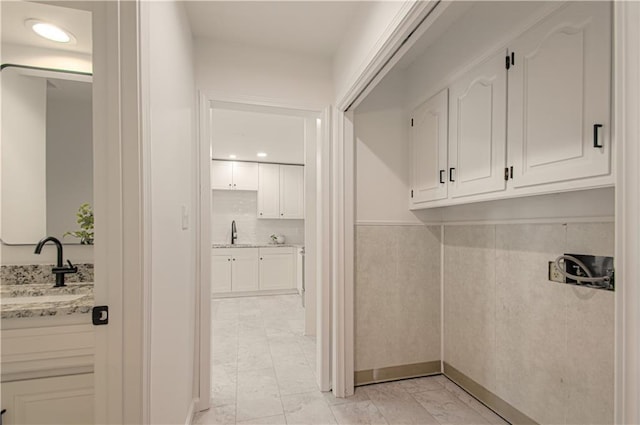 4300 W 112th St, Leawood, KS 66211 - mudroom with light marble finish floors, a sink, baseboards, and recessed lighting