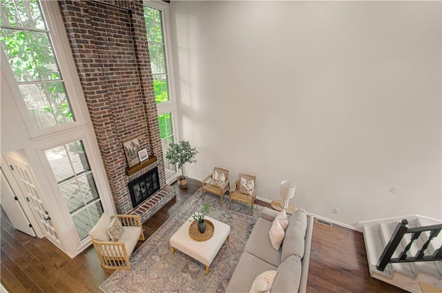4300 W 112th St, Leawood, KS 66211 - living room featuring wood finished floors, a fireplace, and baseboards