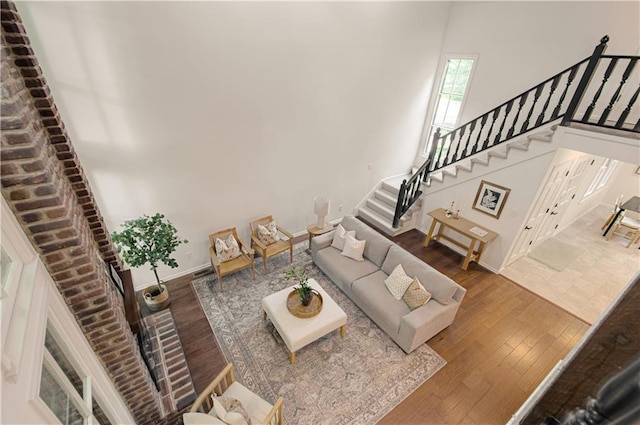 4300 W 112th St, Leawood, KS 66211 - living room featuring wood finished floors, stairway, and baseboards
