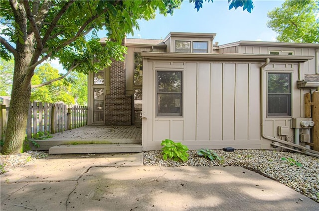 4300 W 112th St, Leawood, KS 66211 - view of front facade with board and batten siding and a patio
