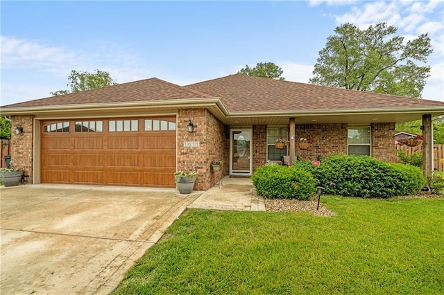 1611 NW Creekland Dr, Grain Valley, MO 64029 - view of front of home featuring brick siding, a garage, a front yard, concrete driveway, and a shingled roof