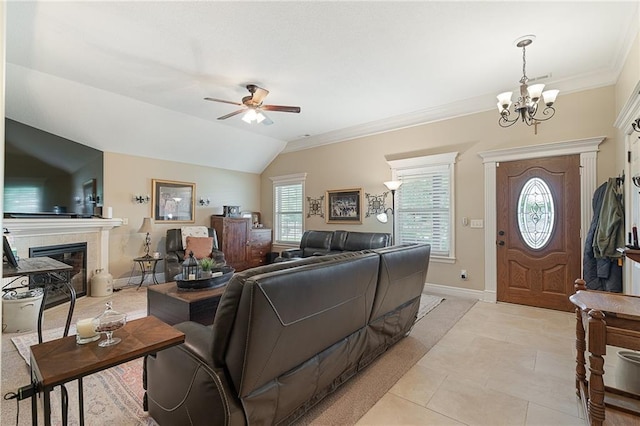 1611 NW Creekland Dr, Grain Valley, MO 64029 - living area with a chandelier, a ceiling fan, healthy amount of natural light, a tiled fireplace, and ornamental molding