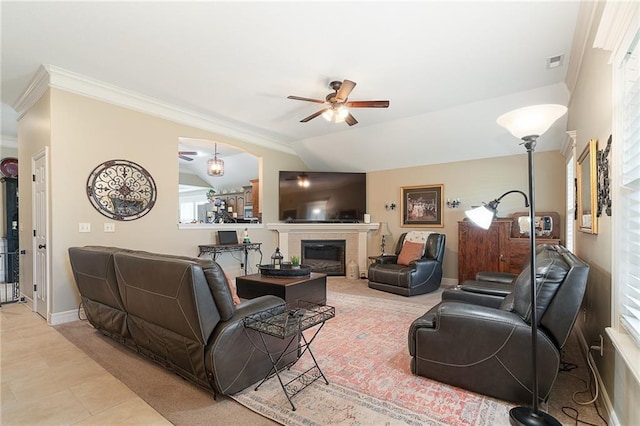 1611 NW Creekland Dr, Grain Valley, MO 64029 - tiled living area with ceiling fan, a glass covered fireplace, crown molding, healthy amount of natural light, and baseboards