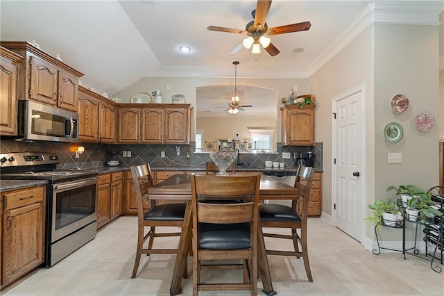 1611 NW Creekland Dr, Grain Valley, MO 64029 - kitchen with appliances with stainless steel finishes, a ceiling fan, brown cabinets, dark countertops, and crown molding
