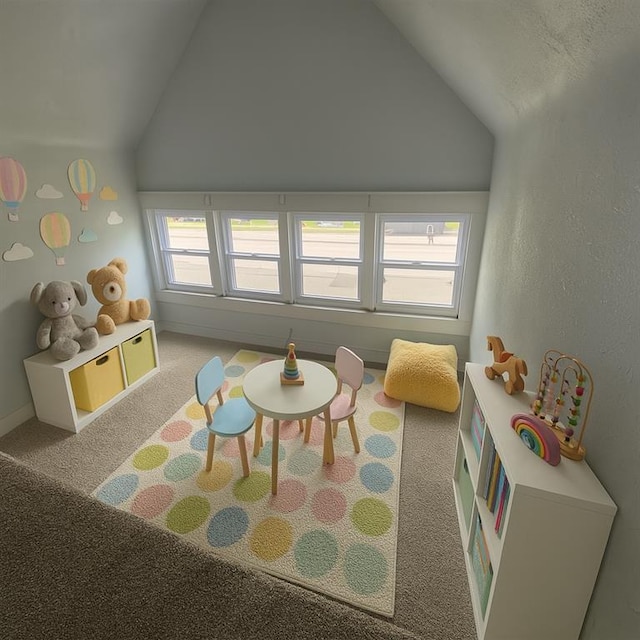 3208 E 31st St, Kansas City, MO 64128 - recreation room featuring lofted ceiling and carpet