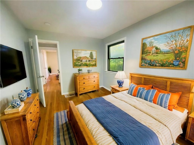 3208 E 31st St, Kansas City, MO 64128 - bedroom with wood finished floors and baseboards